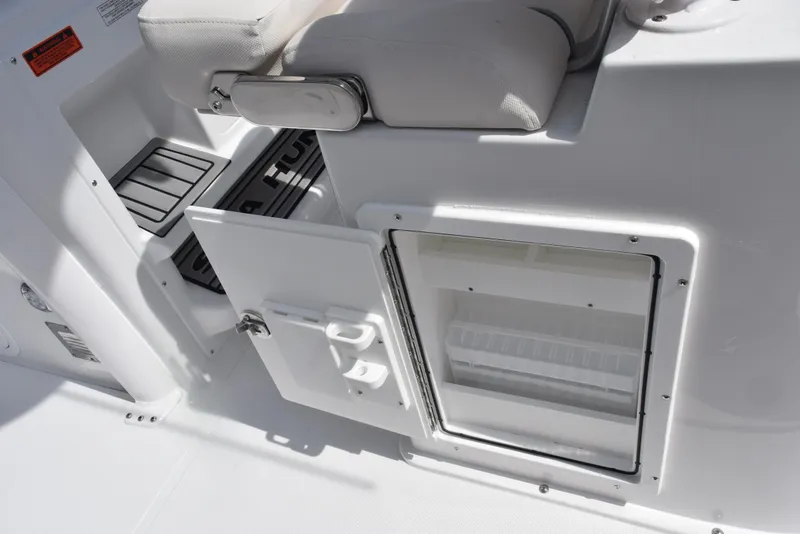Slide: The Image of 2026 Sea Hunt Gamefish 27 Forward Seating boat interior with open storage compartments. - 21