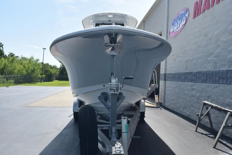 Slide: The Image of 2026 Sea Hunt Gamefish 27 boat on trailer, parked outside a marine dealership. - 3