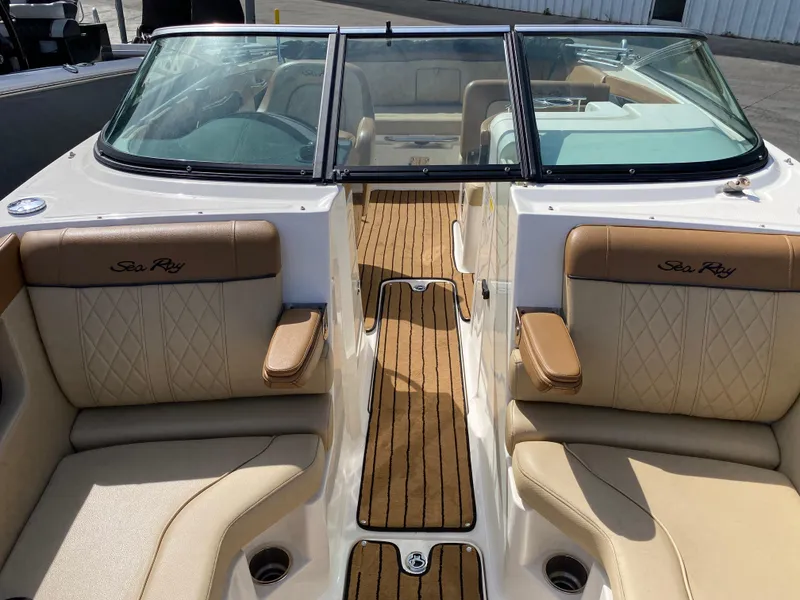 Slide: The Image of 2015 Sea Ray 240 Sundeck interior with tan seating and wood-style flooring. - 13