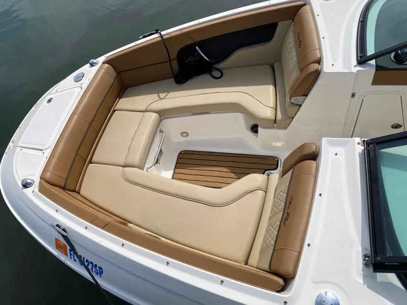 Slide: The Image of 2015 Sea Ray 240 Sundeck boat with tan seating and wood accents. - 18