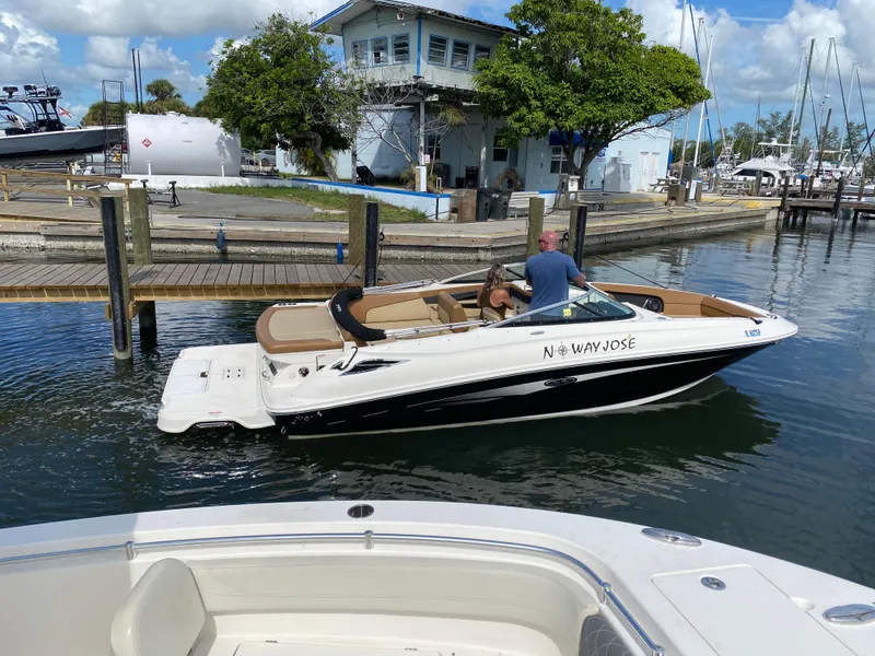 Slide: The Image of 2015 Sea Ray 240 Sundeck boat docked at marina under clear blue sky. - 19