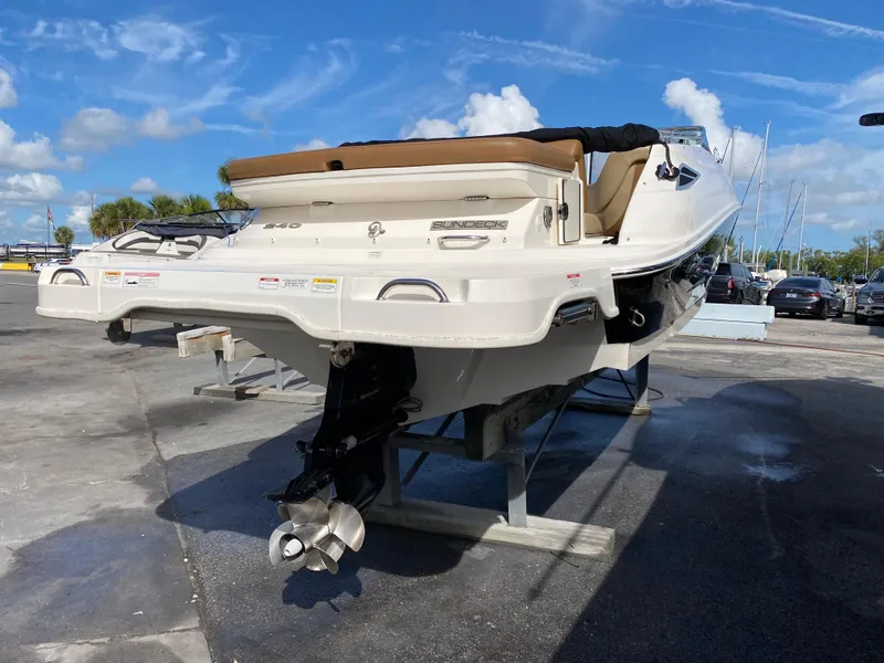 Slide: The Image of 2015 Sea Ray 240 Sundeck boat on display under a clear blue sky. - 3