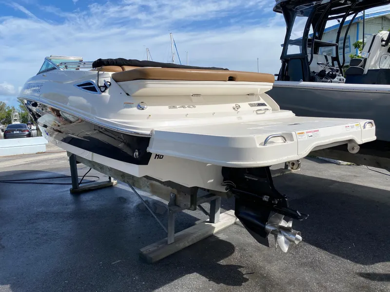Slide: The Image of 2015 Sea Ray 240 Sundeck boat on display, showcasing sleek design and powerful engine. - 4