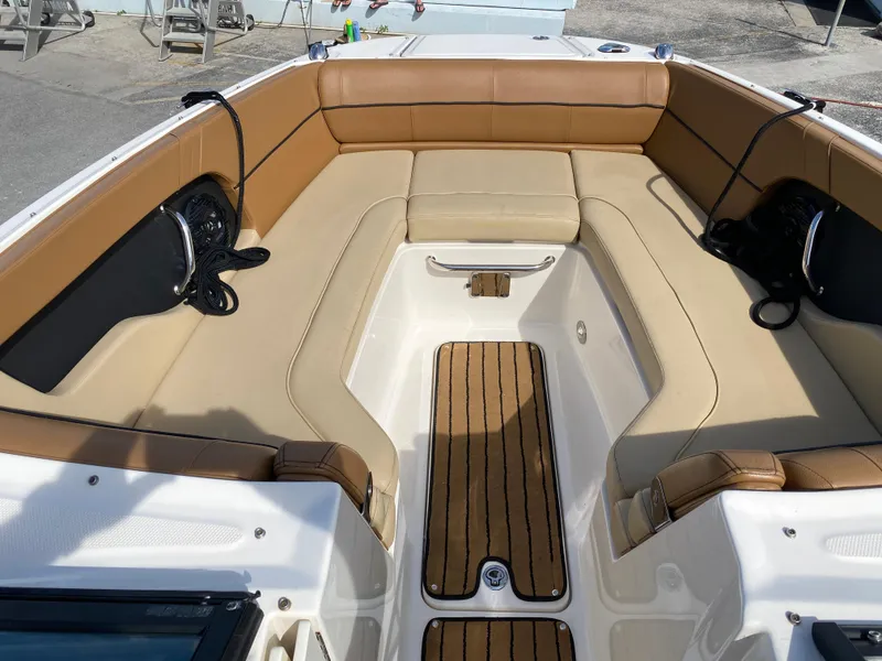 Slide: The Image of 2015 Sea Ray 240 Sundeck interior with tan seating and wood-style flooring. - 8