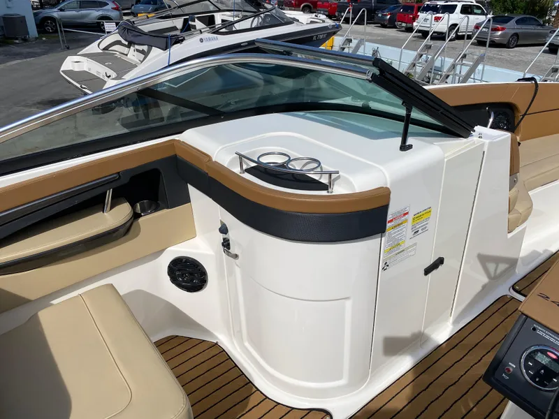 Slide: The Image of 2015 Sea Ray 240 Sundeck interior with tan seating and modern dashboard. - 9
