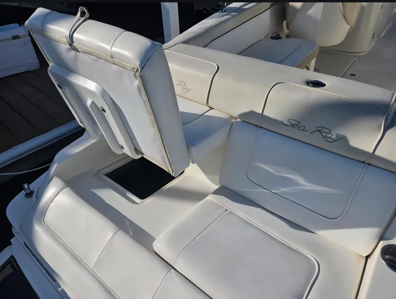 Slide: The Image of 2013 Sea Ray 260 Sundeck boat interior with white cushioned seating. - 20