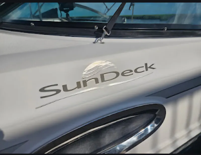 Slide: The Image of 2013 Sea Ray 260 Sundeck boat logo close-up with windshield detail. - 25