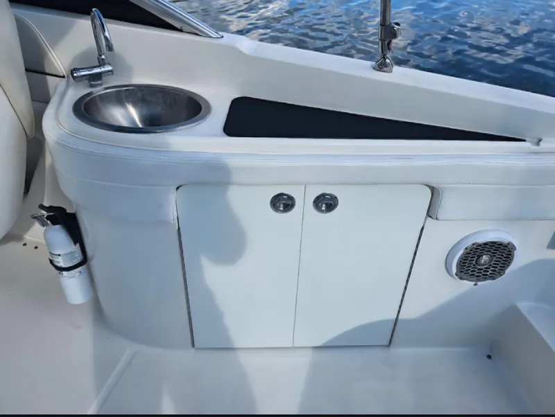 Slide: The Image of 2013 Sea Ray 260 Sundeck interior with sink, storage, and speaker. - 5