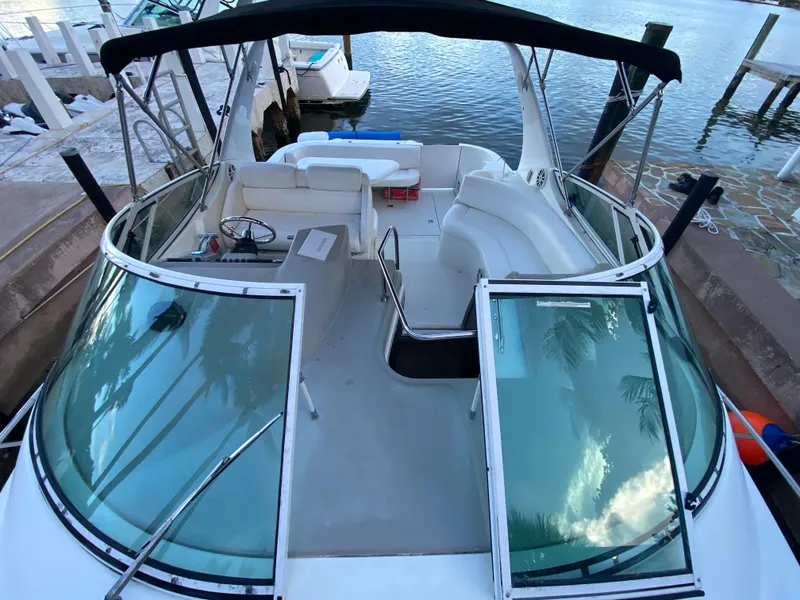 Slide: The Image of 2002 Cruisers Yachts 3372 Express docked, featuring spacious cockpit and sleek design. - 11