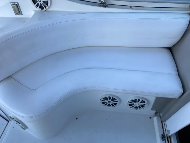 Slide: The Image of White seating area on a 2002 Cruisers Yachts 3372 Express with built-in speakers. - 14