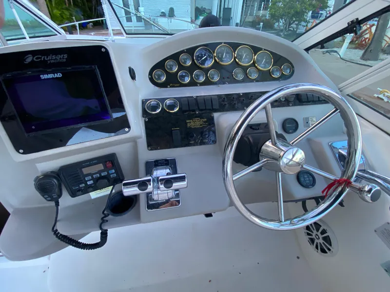Slide: The Image of Helm of 2002 Cruisers Yachts 3372 Express with steering wheel and navigation instruments. - 15