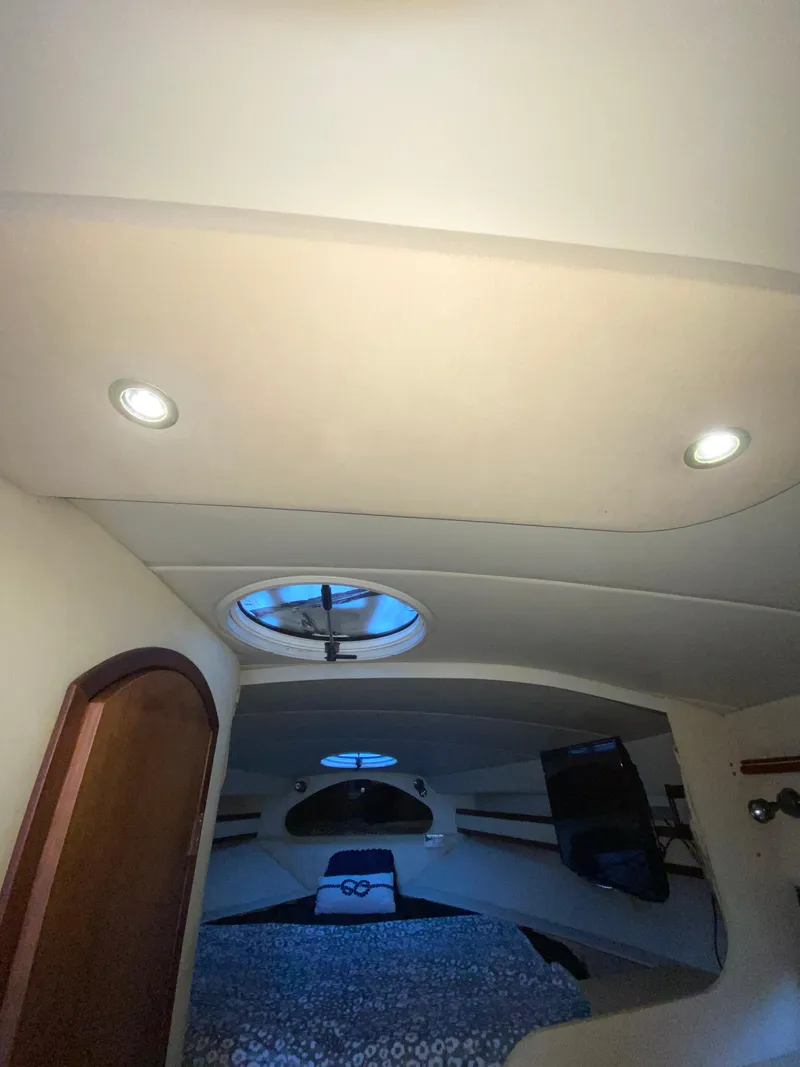 Slide: The Image of Interior cabin of 2002 Cruisers Yachts 3372 Express with bed and porthole. - 22