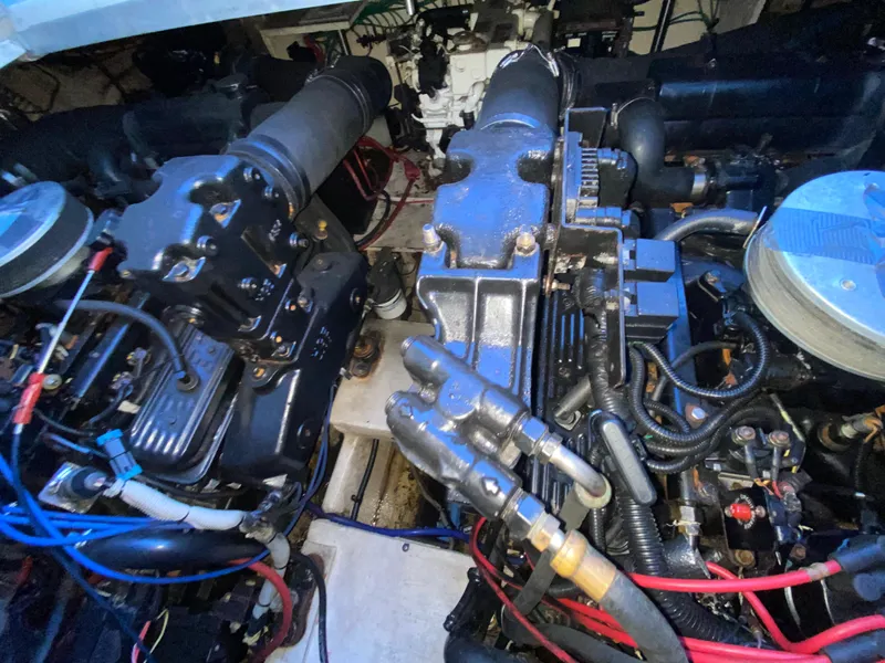 Slide: The Image of Engine compartment of a 2002 Cruisers Yachts 3372 Express, showcasing detailed mechanical components. - 23