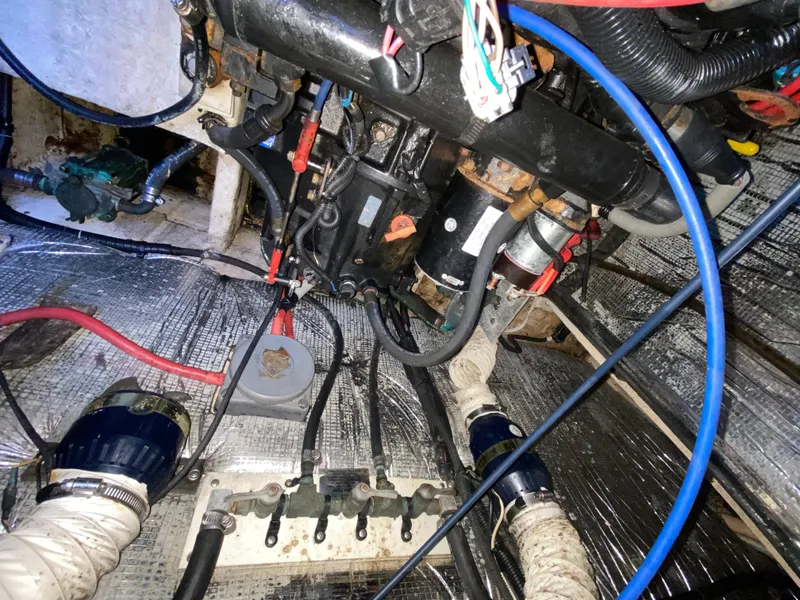 Slide: The Image of Engine compartment of 2002 Cruisers Yachts 3372 Express, showing wiring and mechanical components. - 24