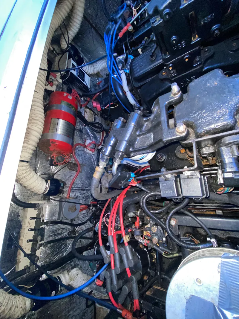 Slide: The Image of Engine compartment of a 2002 Cruisers Yachts 3372 Express, showcasing wiring and components. - 25