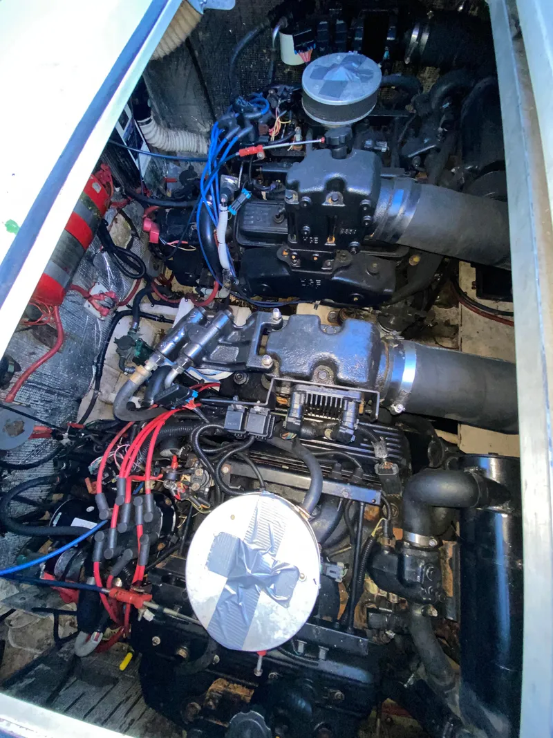 Slide: The Image of Engine compartment of a 2002 Cruisers Yachts 3372 Express, showing detailed mechanical components. - 26