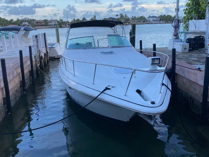 Slide: The Image of 2002 Cruisers Yachts 3372 Express docked in a serene marina setting. - 4
