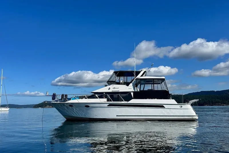 The Image of 1993 Ocean Alexander 460 yacht on calm water under a clear blue sky. - 0