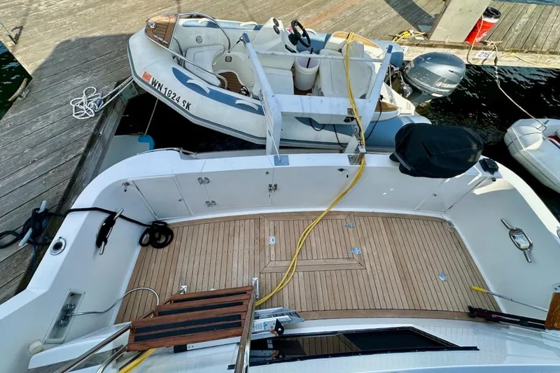 Slide: The Image of 1993 Ocean Alexander 460 yacht with wooden deck, docked alongside inflatable boat. - 17