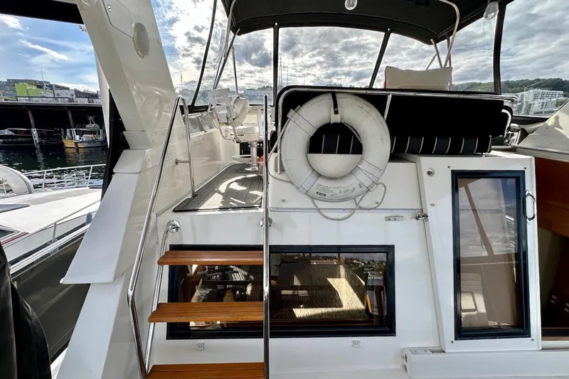 Slide: The Image of 1993 Ocean Alexander 460 yacht with wooden steps and life preserver, docked at marina. - 22