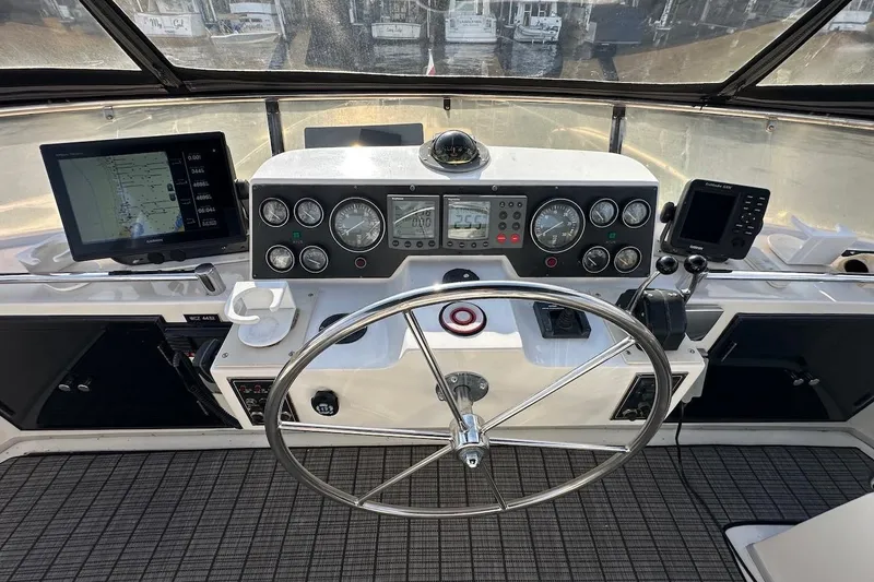 Slide: The Image of Cockpit of 1993 Ocean Alexander 460 yacht with navigation instruments and steering wheel. - 24