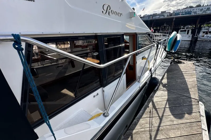 Slide: The Image of 1993 Ocean Alexander 460 yacht docked, showcasing sleek design and waterfront setting. - 27