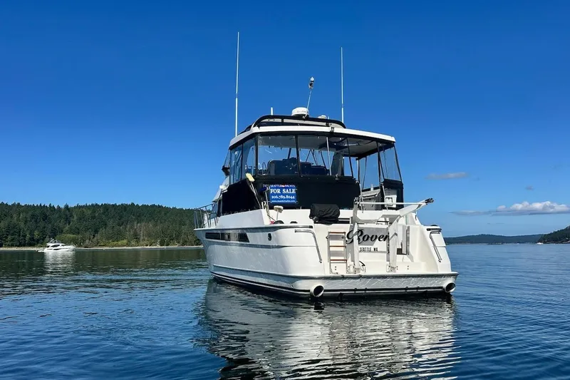 Slide: The Image of Ocean Alexander 460 yacht from 1993 on calm water, clear blue sky background. - 3