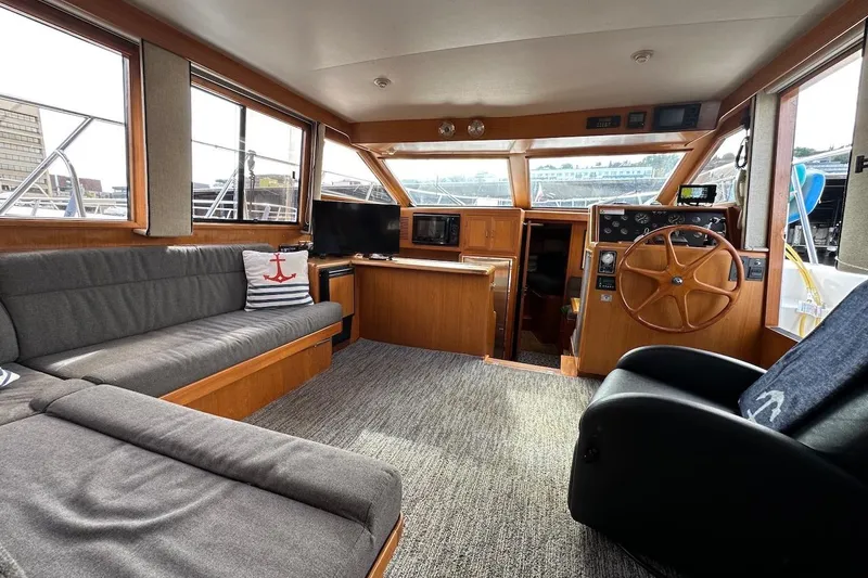Slide: The Image of Interior of 1993 Ocean Alexander 460 yacht with cozy seating and wooden helm. - 33