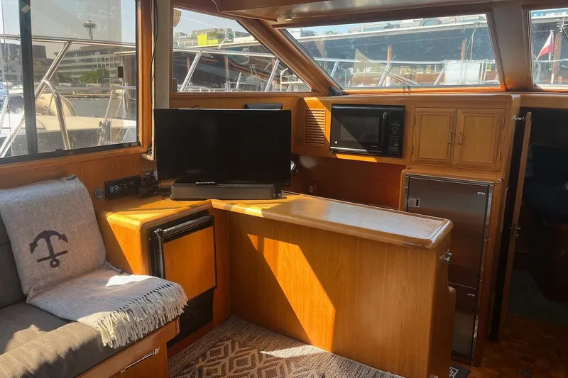 Slide: The Image of Interior of 1993 Ocean Alexander 460 yacht with TV, microwave, and seating area. - 36