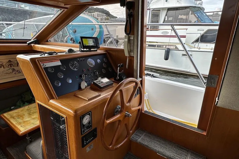 Slide: The Image of Interior helm of 1993 Ocean Alexander 460 yacht with wooden steering wheel and control panel. - 38