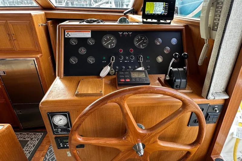 Slide: The Image of 1993 Ocean Alexander 460 helm with wooden steering wheel and navigation instruments. - 39