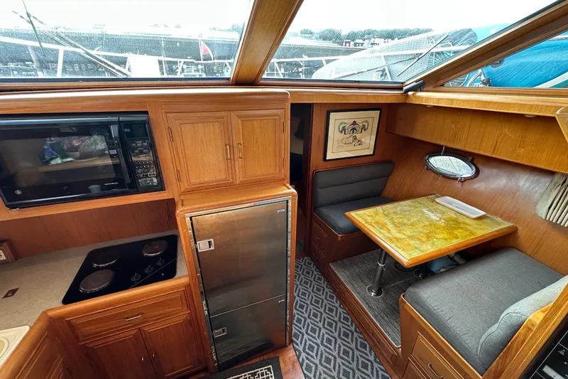 Slide: The Image of Cozy 1993 Ocean Alexander 460 yacht interior with kitchenette and dining area. - 43