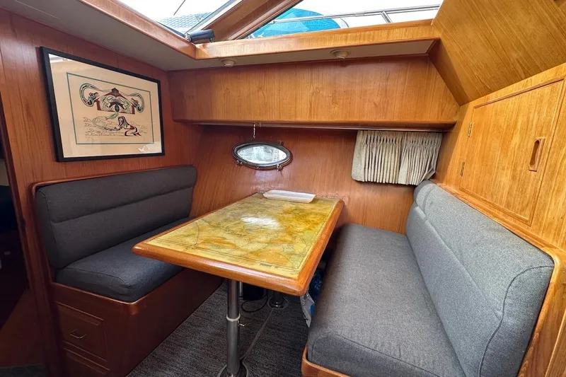 Slide: The Image of Cozy dining area in 1993 Ocean Alexander 460 yacht with wood finish and artwork. - 47