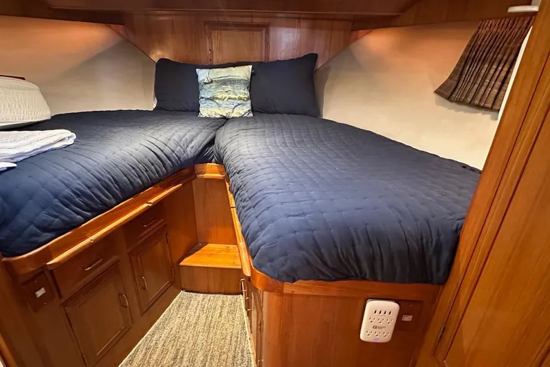 Slide: The Image of Cozy cabin interior of 1993 Ocean Alexander 460 yacht with twin beds and wooden cabinetry. - 48