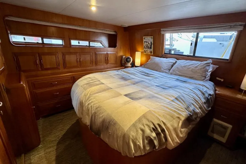 Slide: The Image of Cozy bedroom in 1993 Ocean Alexander 460 yacht with wood paneling and large bed. - 53