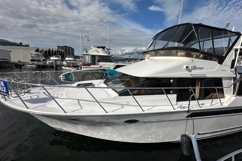 Slide: The Image of 1993 Ocean Alexander 460 yacht docked, featuring sleek design and "Rover" nameplate. - 6