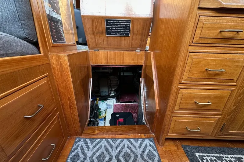 Slide: The Image of Engine compartment access in 1993 Ocean Alexander 460 yacht, featuring wooden cabinetry and storage drawers. - 61