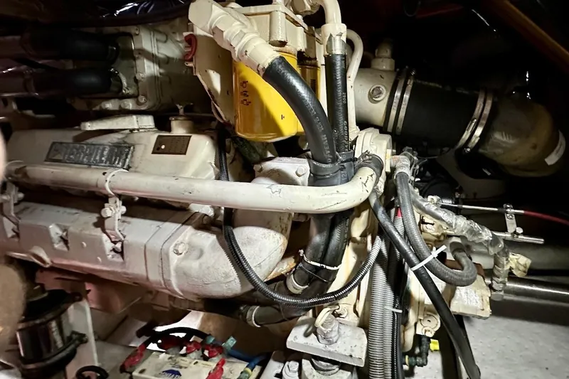 Slide: The Image of Engine compartment of a 1993 Ocean Alexander 460 yacht, showcasing mechanical components and wiring. - 64