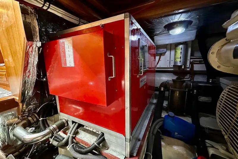 Slide: The Image of Engine room of 1993 Ocean Alexander 460 yacht with red machinery and piping. - 68