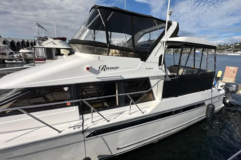 Slide: The Image of 1993 Ocean Alexander 460 yacht docked, featuring sleek design and spacious upper deck. - 7