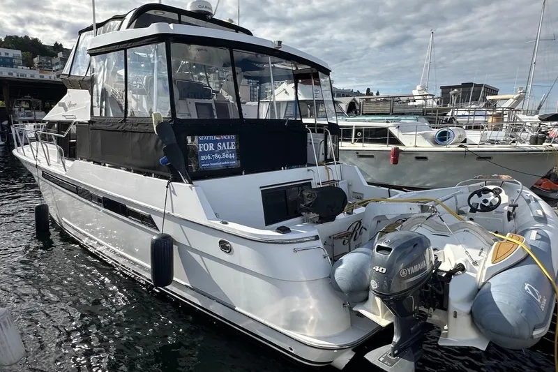 Slide: The Image of Ocean Alexander 460 yacht from 1993, docked and for sale, featuring a Yamaha outboard motor. - 8
