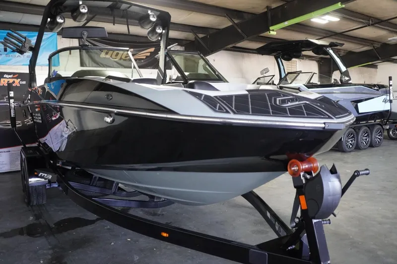 Slide: The Image of 2024 MB B52 23 Classic boat in showroom, black and gray design, on trailer. - 14