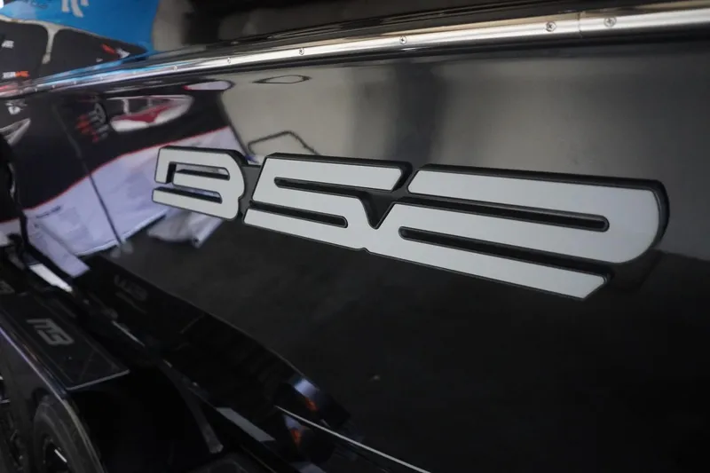 Slide: The Image of 2024 MB B52 23 Classic boat with sleek black exterior and bold logo. - 16