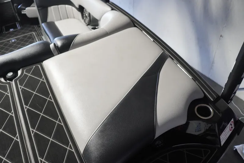 Slide: The Image of 2024 MB B52 23 Classic boat interior with sleek black and gray seating design. - 20