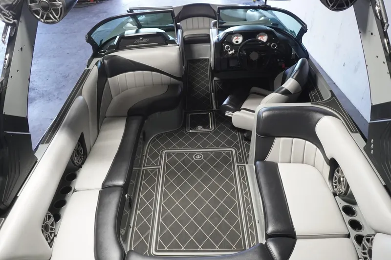 Slide: The Image of 2024 MB B52 23 Classic boat interior with luxurious seating and modern dashboard. - 22