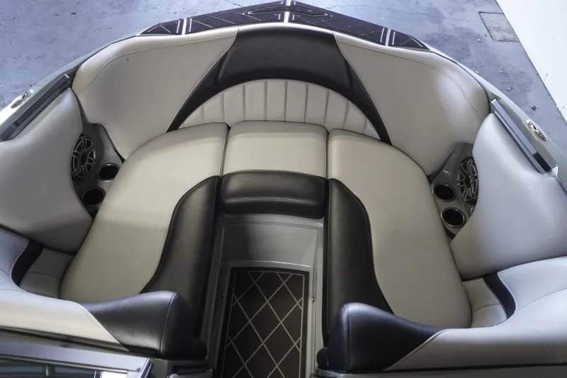 Slide: The Image of 2024 MB B52 23 Classic boat interior with cushioned seating and cup holders. - 23