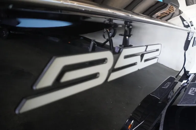 Slide: The Image of 2024 MB B52 23 Classic boat with sleek black exterior and bold logo. - 3