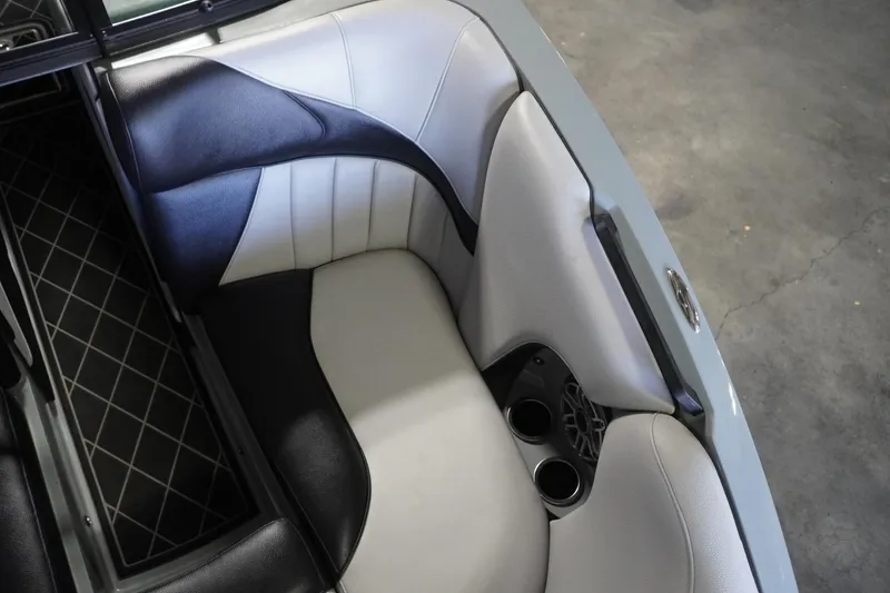 Slide: The Image of 2024 MB B52 23 Classic boat interior with stylish black and white seating and cup holders. - 32