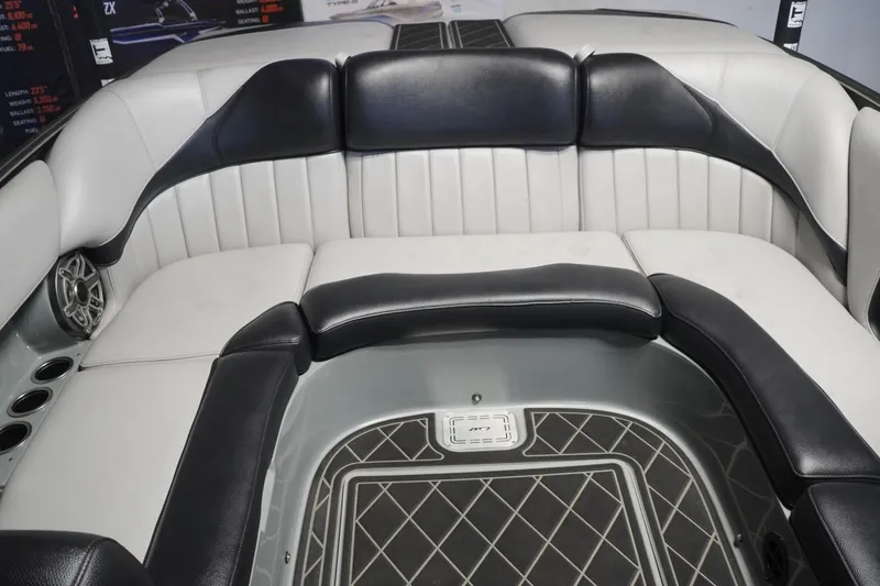 Slide: The Image of 2024 MB B52 23 Classic boat interior with black and white seating and speaker system. - 37