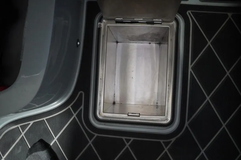 Slide: The Image of 2024 MB B52 23 Classic interior storage compartment with open lid, showing sleek design. - 43